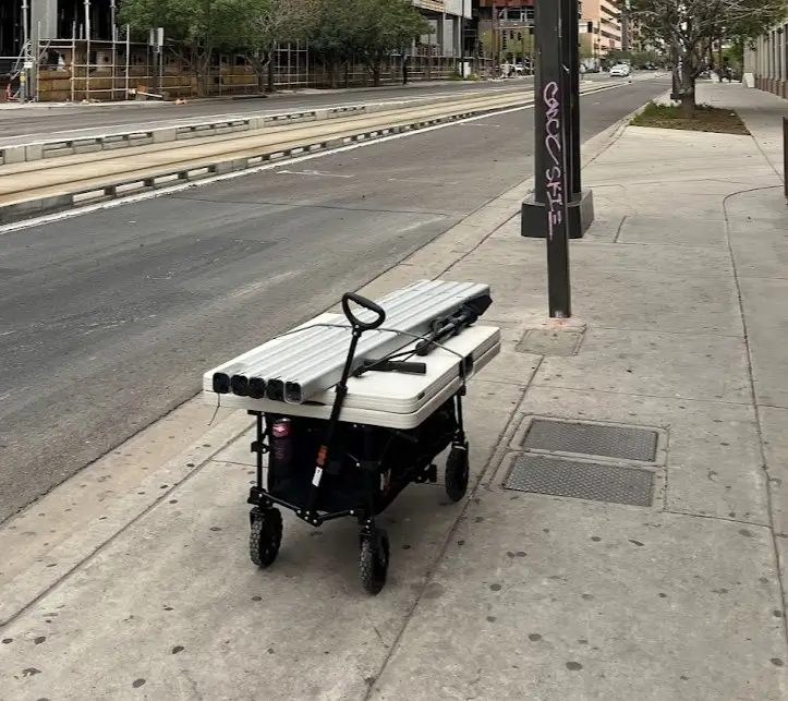 Bike Valet Portable Racks being transported on a wagon with a foldable table