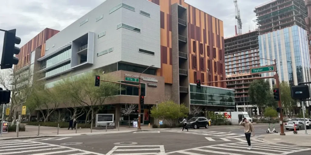 Busy scramble crossing with pedestrians and vehicles at Taylor Street intersection in urban setting at Arizona State University (ASU) in Downtown Phoenix (DTPHX)