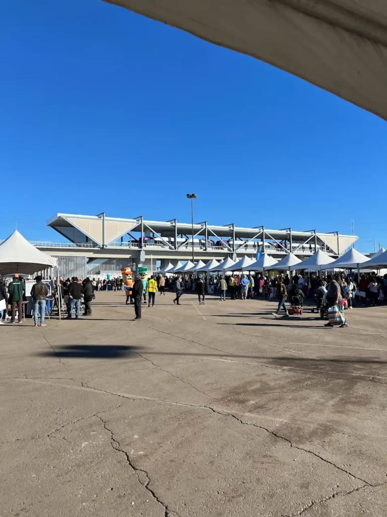 Crowd gathered at an event near a modern transit station Transit-Oriented Development