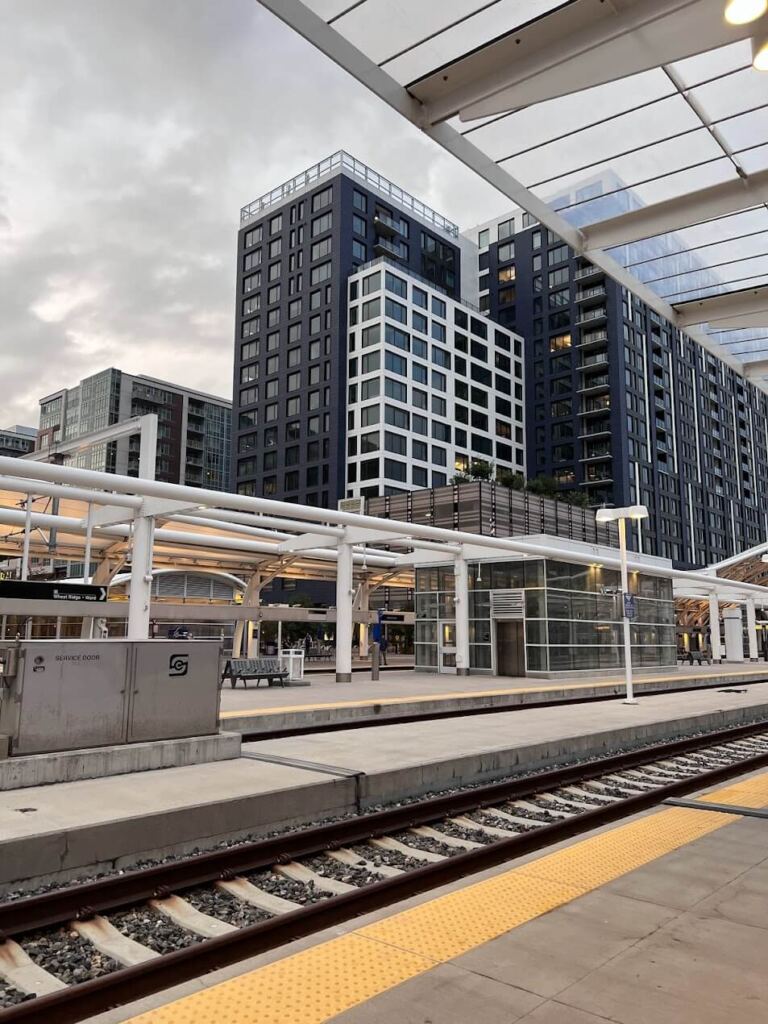 Contemporary train station with high-rise buildings in the background Transit-Oriented Development