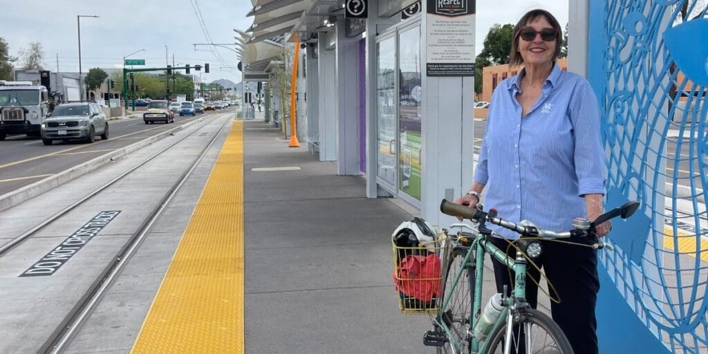 Suzanne Day with her bike at a Valley Metro light rail station in Phoenix.