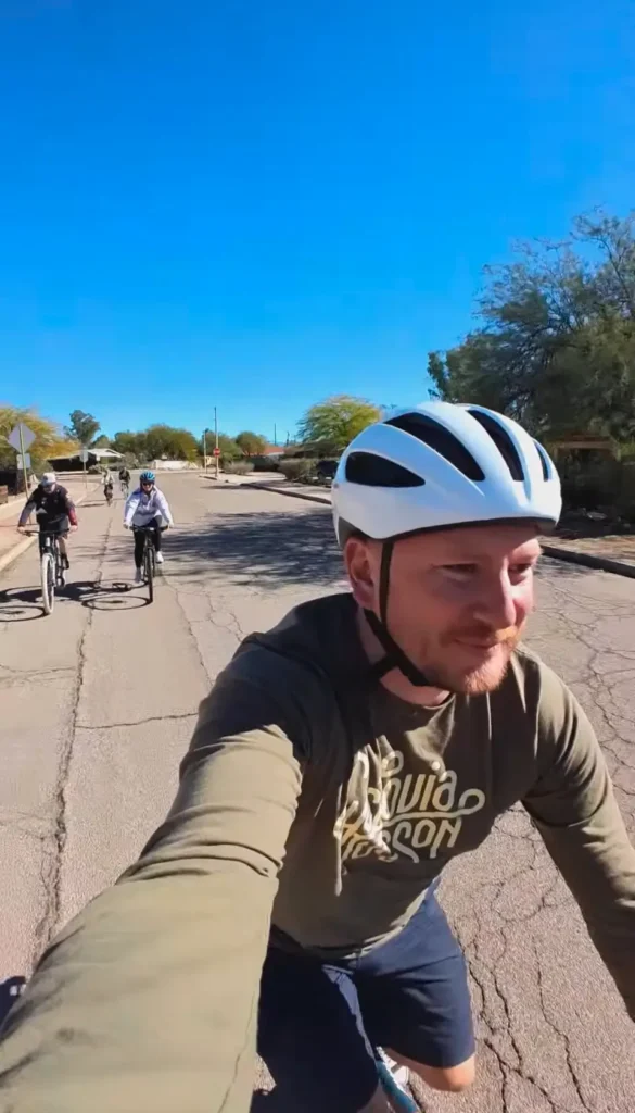 Car-Free Tucson on a group bike ride wearing a cyclovia Tucson shirt
