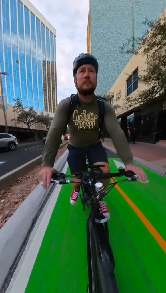 Car-Free Tucson on a two cycle bike lane wearing Cyclovia Tucson shirt from Living Street Alliance